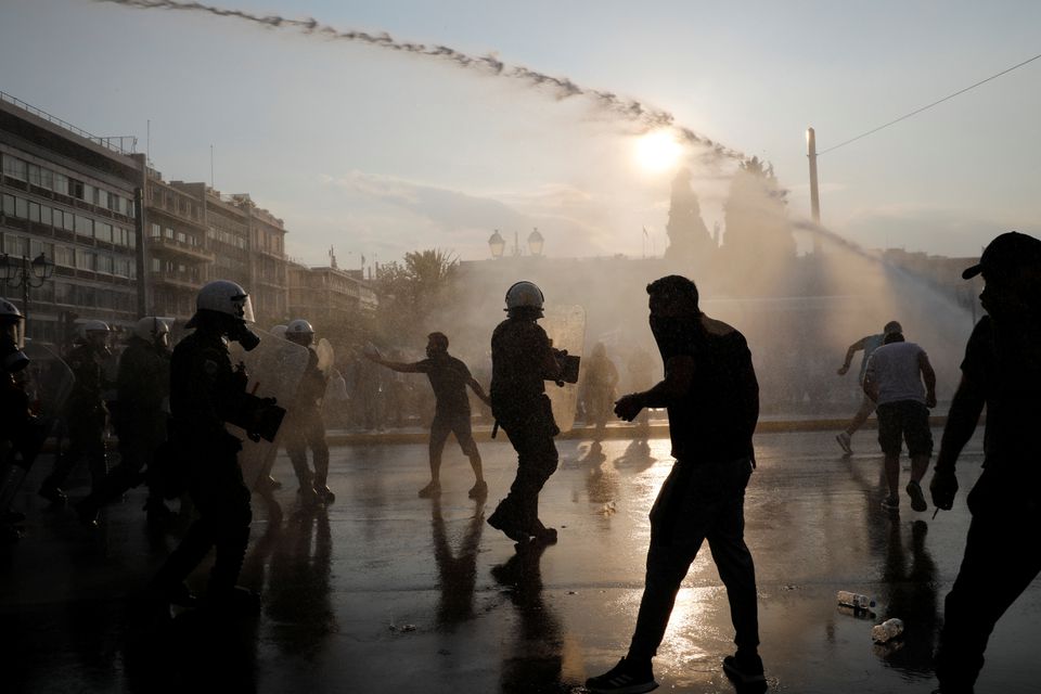Police use water cannon against demonstrators during a protest against coronavirus disease (COVID-19) vaccinations outside the parliament building, in Athens, Greece, July 21, 2021. REUTERS/Costas Baltas
